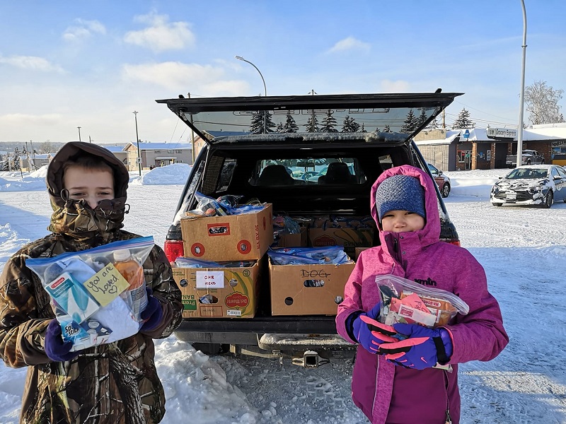 Two youth from Prince George CC distribute Blessing Bags