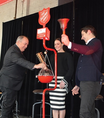 Tessa Virtue and Scott Moir ring the kettle bells at The Salvation Army's Hope in the City event in Victoria in December 2018.