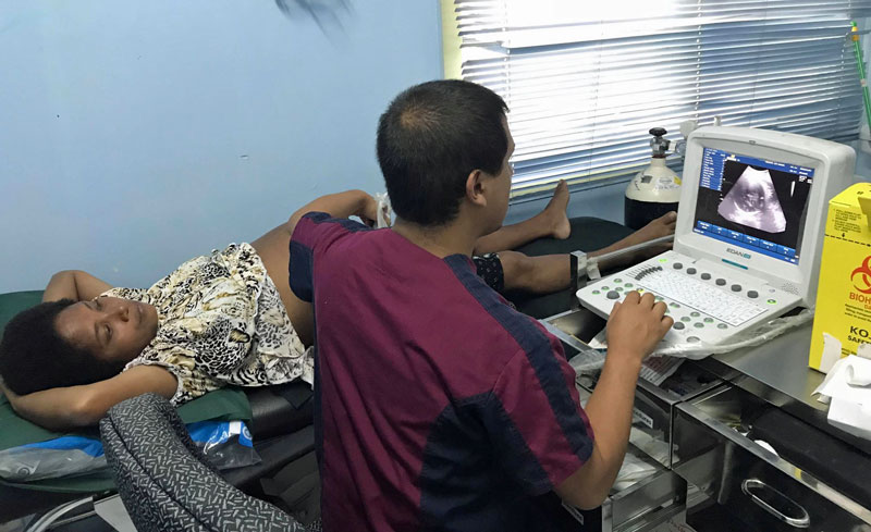 Dr. Marco Herrera Lopizic performs an ultrasound at the Koki Urban Health Center