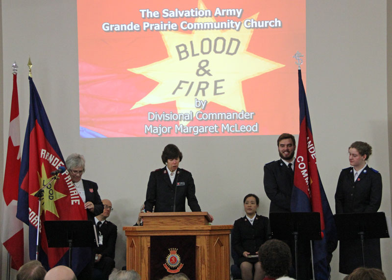 Major Margaret McLeod offers a prayer of dedication for the new corps flag