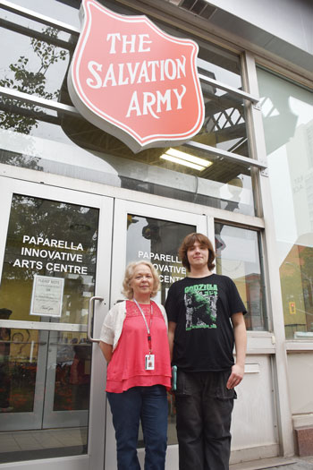 Theresa Speers and Stephen stand by the entrance to the Paparella Innovative Arts Centre
