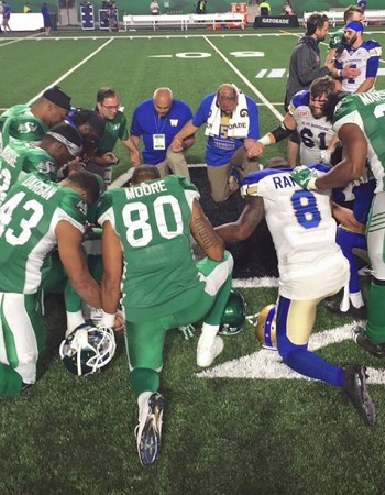 Lorne Korol with members of the Winnipeg Blue Bombers and Saskatchean Roughriders