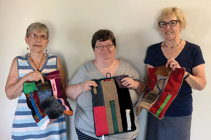 Elaine Frail, Carolyn Goyetche and Sheila Banks show off weighted sensory pads