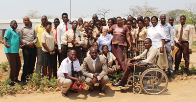 Photo of Mjr Donna Barthau with staff and students, including Vernon, from Chaanga Secondary School in Zambia