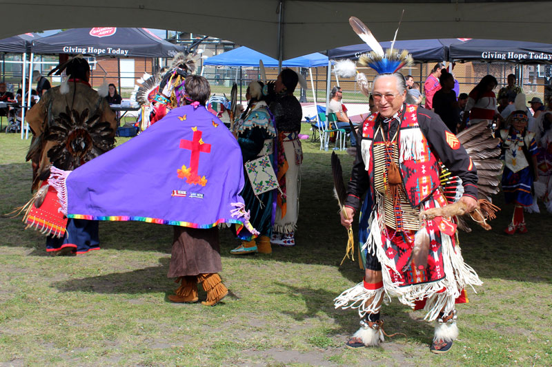 Dr. Casey Church (Pokagon Band Potawatomi), director of Wiconi International, dances at the pow wow