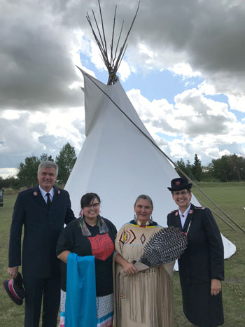 Colonel Edward Hill; Cpt Crystal Porter, DYS, Prairie Div; Mjr Shari Russell; and Colonel Shelley Hill, TSWM, gather by a tipi