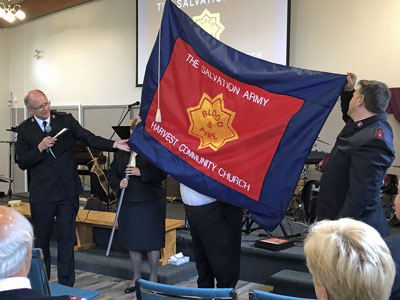 Salvationists hold a Salvation Army flag