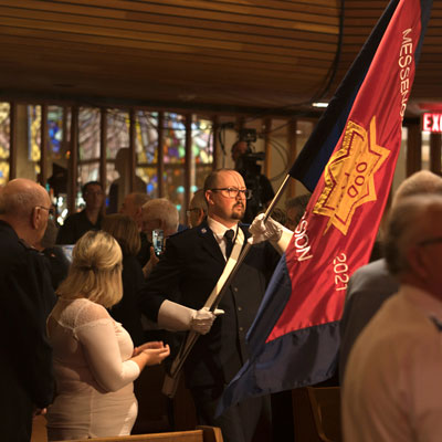 Cdt Jory Hewson carries the sessional flag down the aisle at Heritage Park Temple