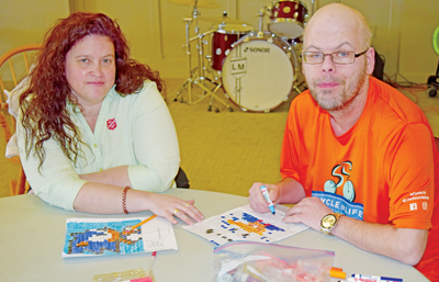 Photo of Mjr Shelly Rands with Dennis at a table