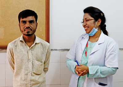 Photo of medical officer at the leprosy control clinic with a patient cured of the disease
