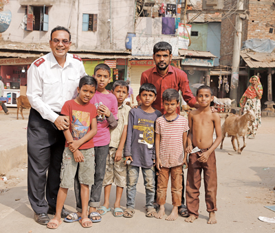 Photo of corps officer with children outside clinic
