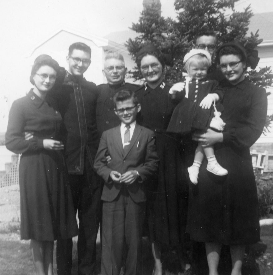 Black and white photo of the Cole Family. Mjr Ross and Mrs. Beulah Cole are in the middle, with Oren Cole in front. 