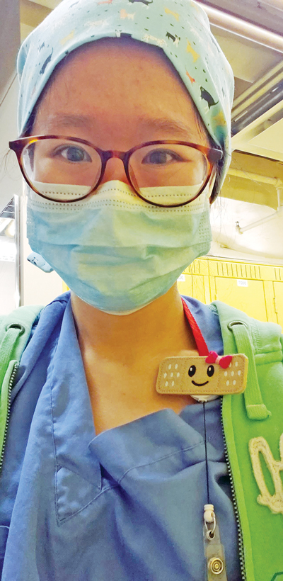 Photo of Peace Lin wearing nurse uniform and mask