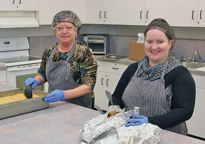 Photo of volunteers preparing lunch for a local school 