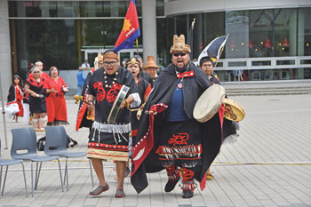 Damian Azak beats drum during congress and commissioning events in Vancouver in 2019