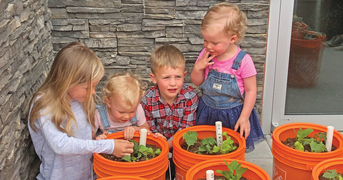 Children check out the bucket gardens available for free at The Salvation Army’s Renew Church 