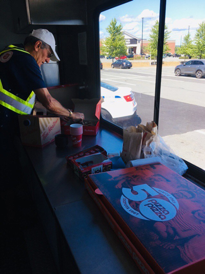 Volunteer Tom Banfield serves lunch from the community response vehicle.