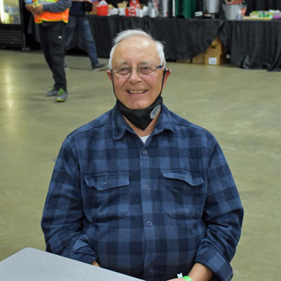 Bill Blokland sits at a table at the Tradex