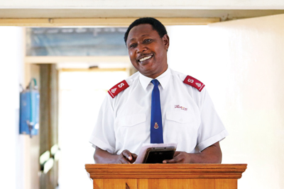 Lt-Col Frazer Chalwe stands in a pulpit to lead morning devotion