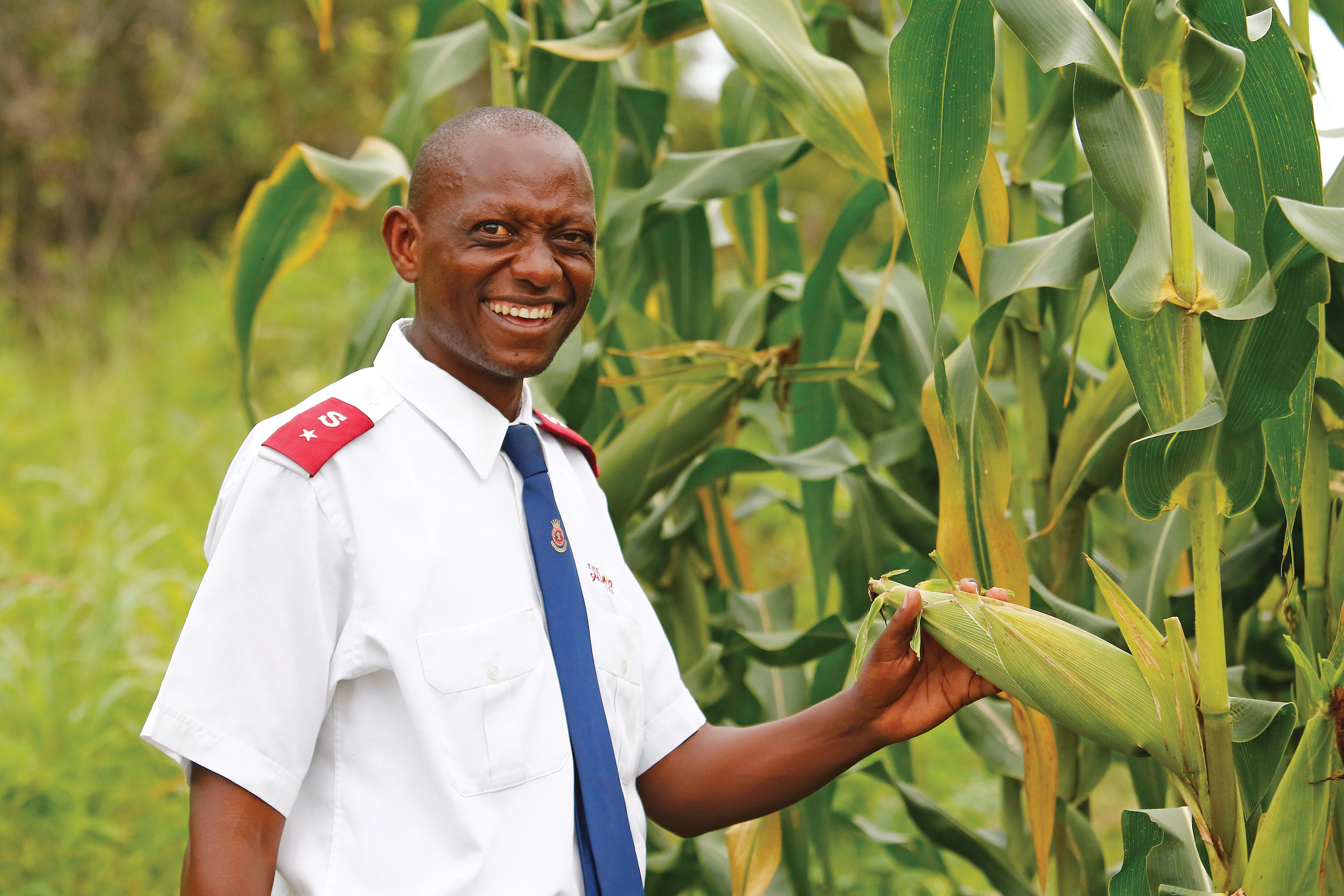 Norman Borlaug, Nobel laureate, holds a stalk of corn 