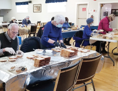 Members of the Alberni Valley corps make sandwiches as part of Sandwich Church