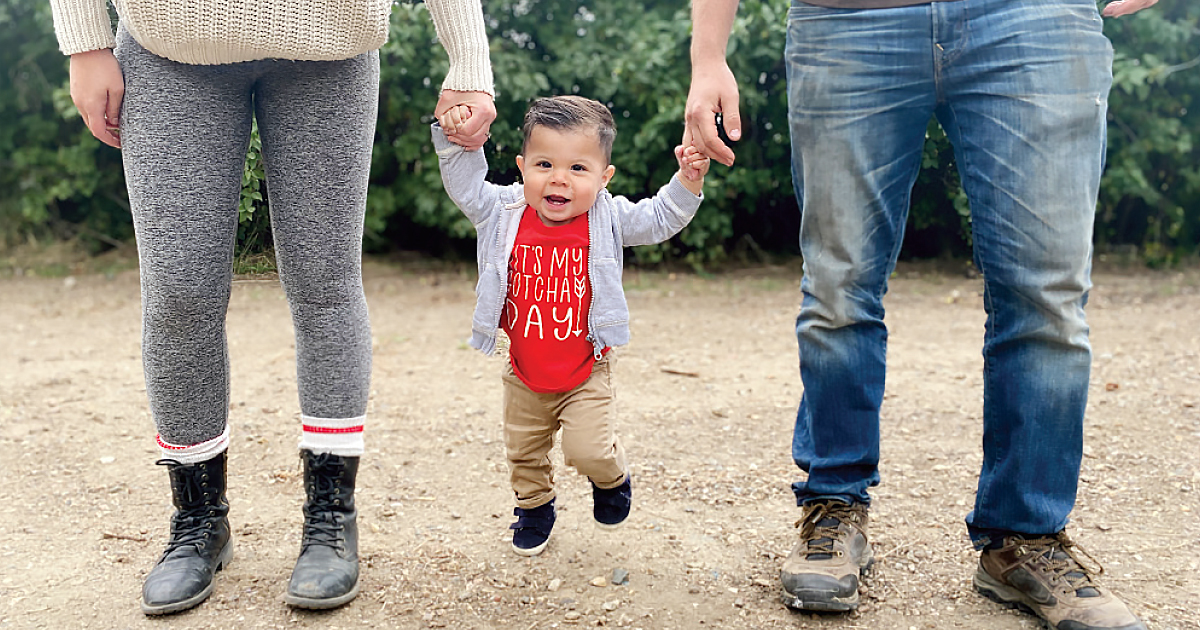 Ezra on a “walk” with his parents