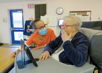 Staff aids resident with virtual visit
