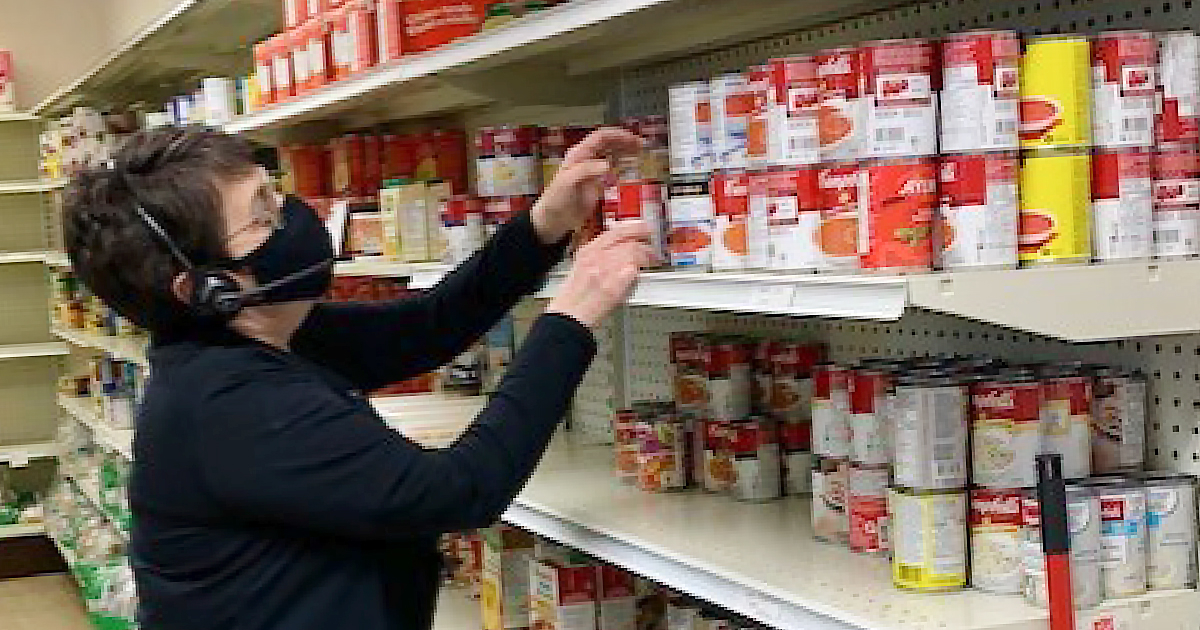 Judy Peifer stocks shelves as food requests increase