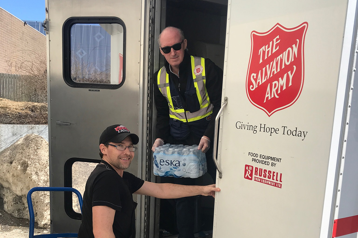 Volunteers deliver hot meals to guests staying at a Salvation Army pop-up shelter in Halifax
