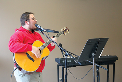 Booth UC student Jaden Castelli showcases one of his talents at a Booth UC coffee-house event 