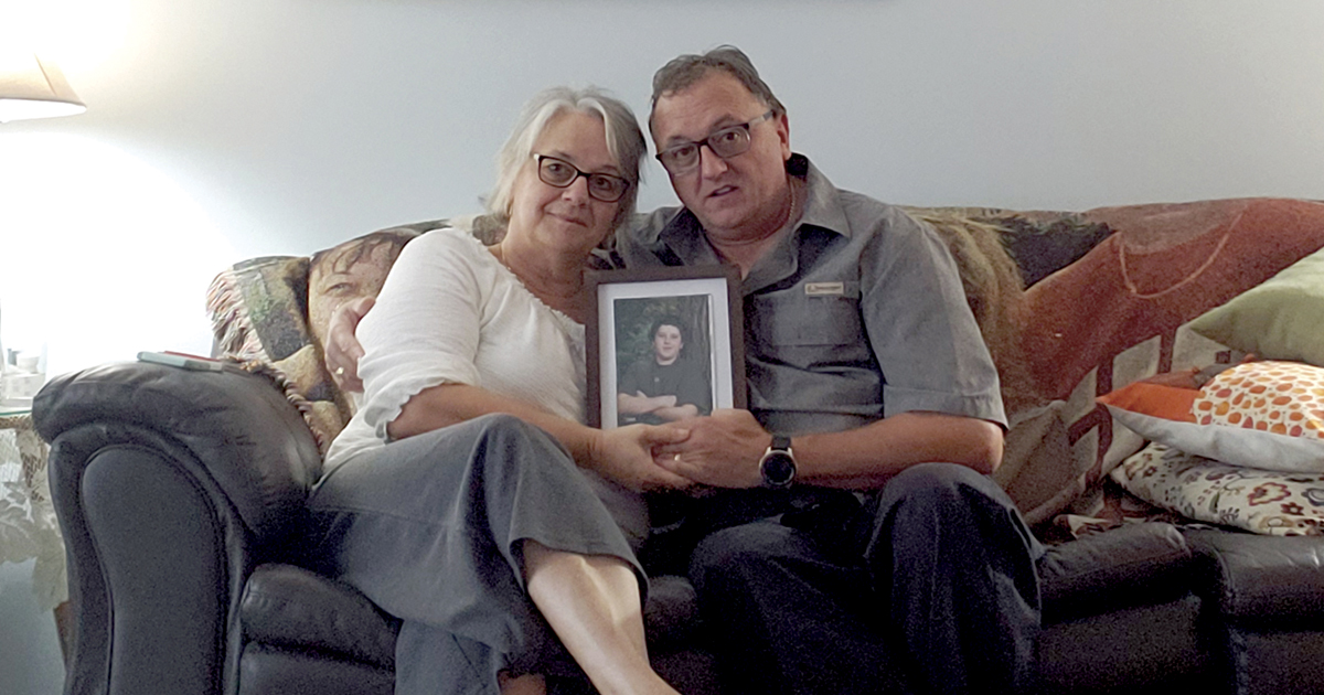 Kathleen and Darren Thompson hold a picture of their son, Andrew