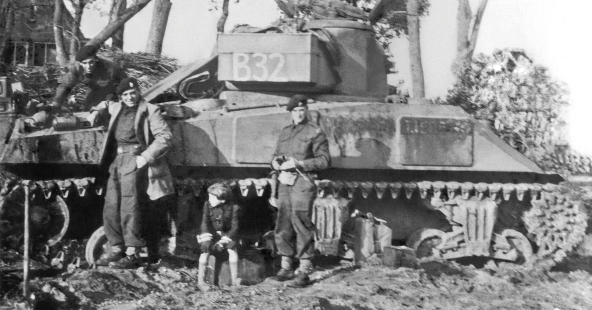 Henry Bellegarde stands with some of the crew of his tank, a Dutch boy next to him
