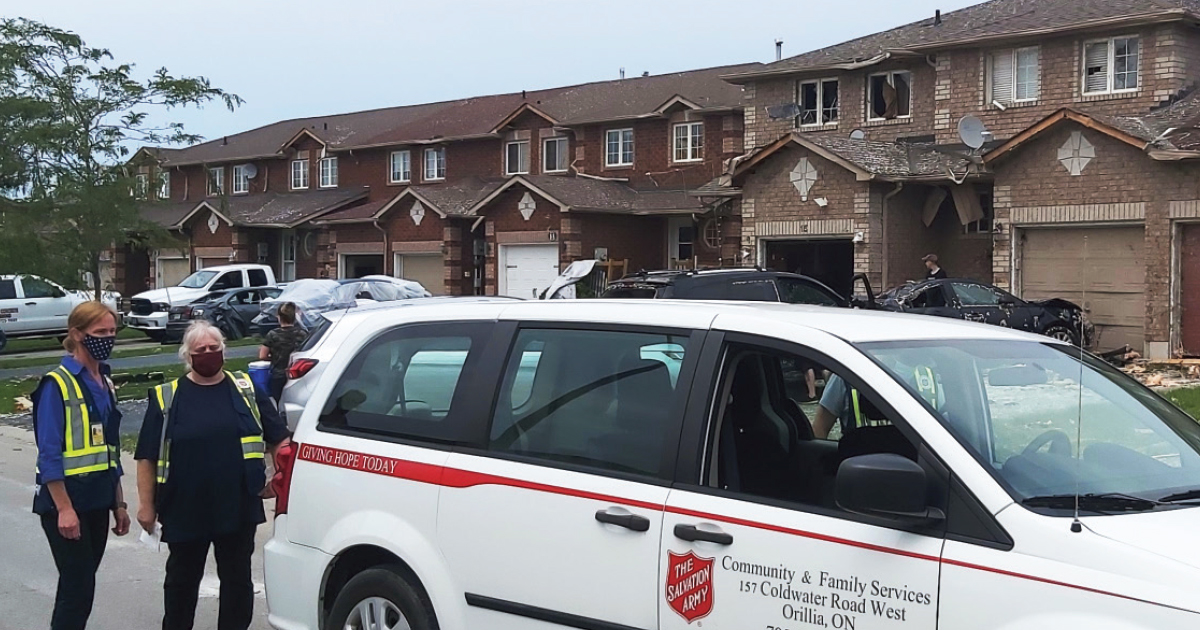 Emergency disaster services volunteers provide support in a tornado-affected neighbourhood