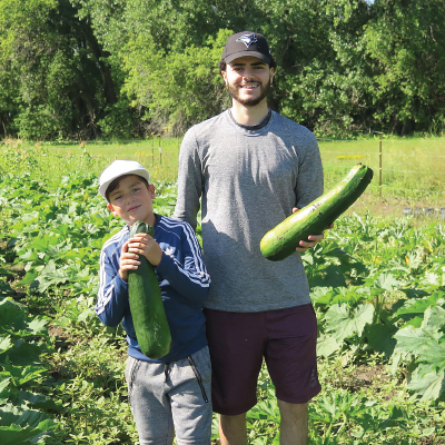Lavan and Haeder Naso with produce from the farm