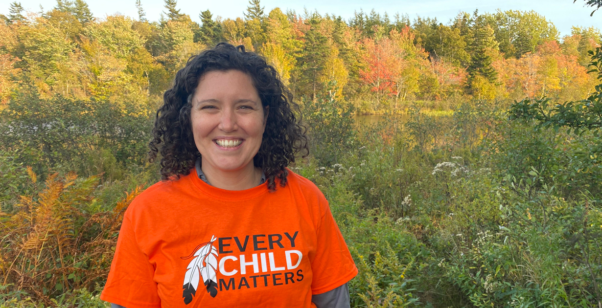 Lt Jenelle Durdle wears an orange T-shirt with the words "Every Child Matters"