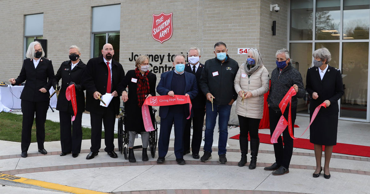 Salvation Army leaders and other dignitaries cut the ribbon at the grand opening event