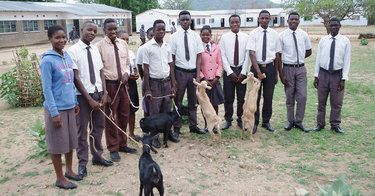 Students from Chaanga Secondary School in Zambia pose during a goat distribution ceremony