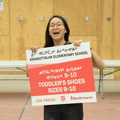 Colleen Chau holds on sign