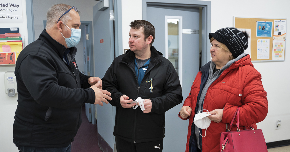 Eugen and Julia confer with Salvation Army director Leigh Rowney