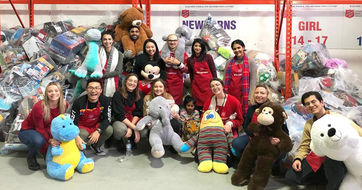 Ana and a team from work sort toys at a Salvation Army holiday gift centre