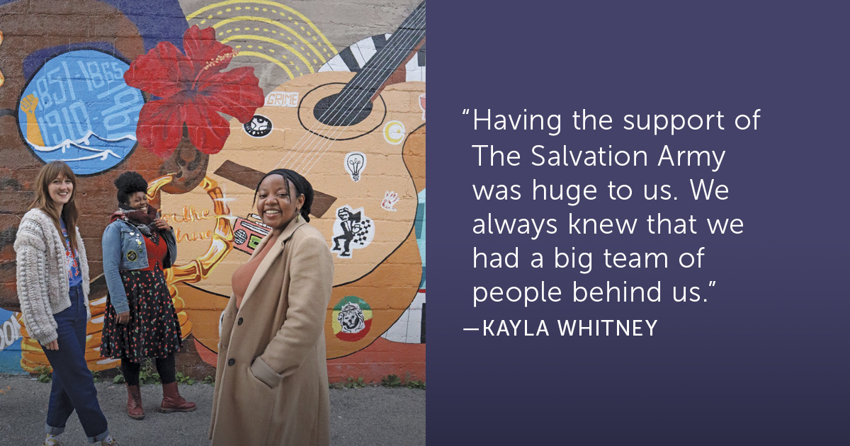 Kayla Whitney, Tandeka Tremblay and Aichoucha Haidara stand before the mural they created