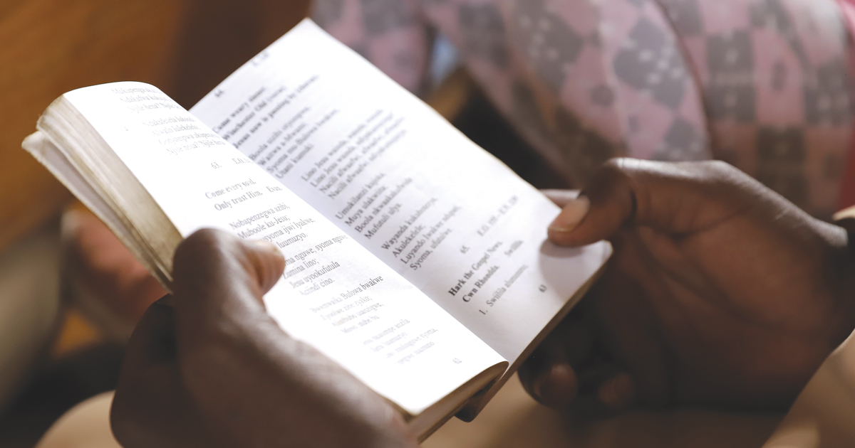 Photo of hands holding an open Bible