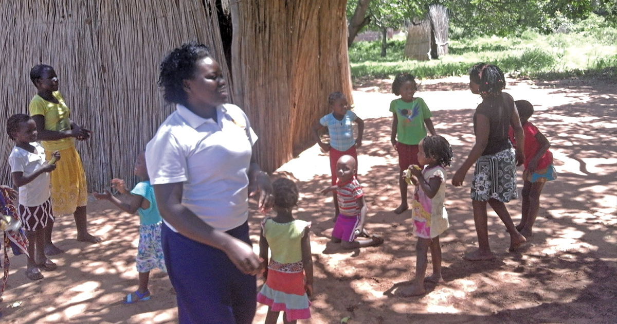 Lt Delfina Zualo, project officer in the Mozambique Tty, enjoys a moment with children