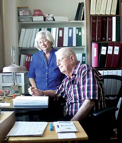 Patricia and Dennis Welbourn examine the stamp collection