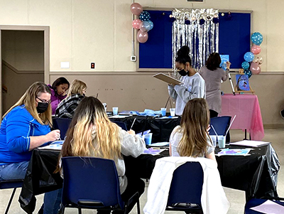 The girls at Edmonton Crossroads CC participate in a paint night led by a volunteer (Photo: Kerri Taylor)