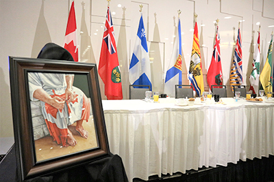 A framed painting of the Canadian flag at the hands and feet of Jesus was gifted to Joy Smith and Bill Adsit, guest speakers