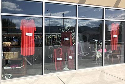 Photo of red dresses in thrift store window