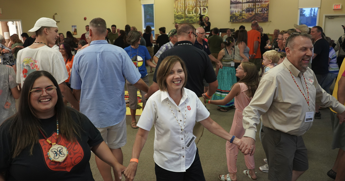 Cpt Crystal Porter, Commissioner Tracey Tidd and Lt-Col Les Marshall join in a round dance