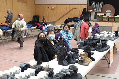 Tables piled high with new clothes and supplies