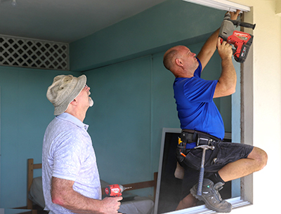 Volunteers from the Ont. Div install energy-efficient windows at Evangeline Residence